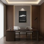 Modern office interior with a desk, chairs, and a framed picture of a car on the wall.