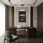 Modern office interior with a desk, chair, and framed picture on the wall.